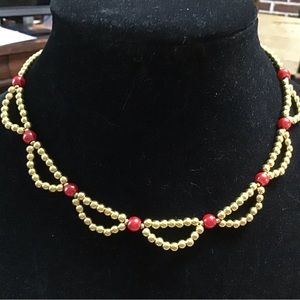 women's gold metal necklace with red faux pearls and a large lobster claw clasp